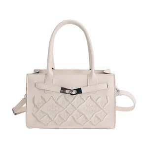 Elegant beige leather handbag with intricate embroidery and metallic twist lock detail