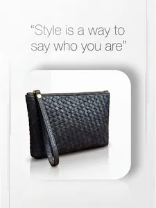Detail of black woven leather clutch bag with golden zipper and leather wrist strap