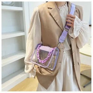 Detailed view of clear square crossbody bag with purple chain and adjustable strap