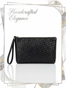 Detail of black woven texture clutch bag featuring gold zipper and elegant leather wristlet