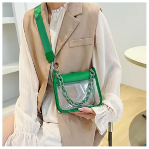 Detailed shot of transparent green PVC crossbody bag with thick plastic chain and nylon strap
