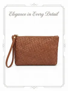 Detail of brown woven leather clutch with wrist strap and elegant metallic zipper