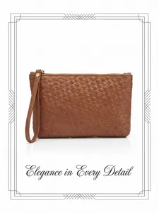 Detail showing high-quality brown woven leather texture and sturdy metal zipper of the clutch