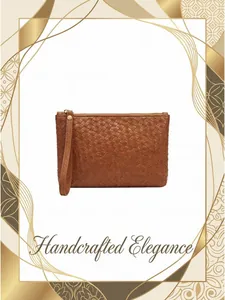 Detail of brown woven leather clutch with secure wrist strap and golden metal zipper
