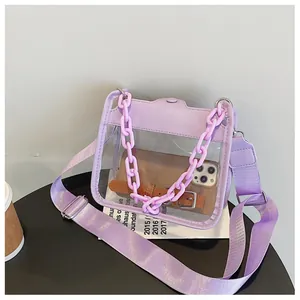 Detail view of purple transparent PVC bag with large chain handle and woven strap
