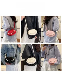 Detail view of mini shell shaped crossbody bag with large pearl chain in four colors