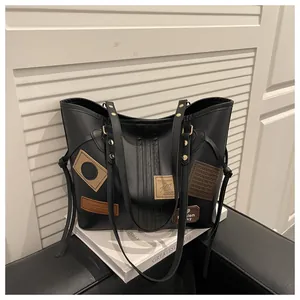 Detail view of vintage tote bag with PU leather patches and gold metallic rivets
