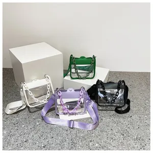 Detailed view of colorful transparent PVC crossbody bags with leather trim and thick chains