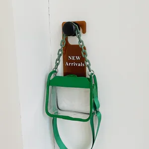 Green and transparent square crossbody bag with plastic chain handle and fabric strap