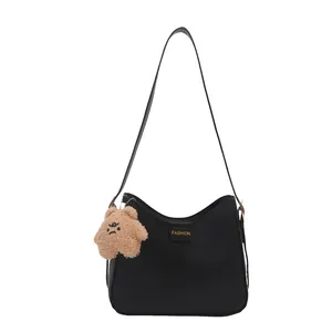Minimalist black faux leather shoulder bucket bag with a cute brown plush bear pendant
