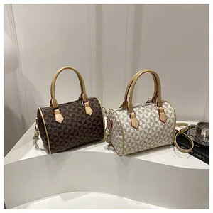 Detail of Boston bags with geometric triangle patterns in brown and white tones