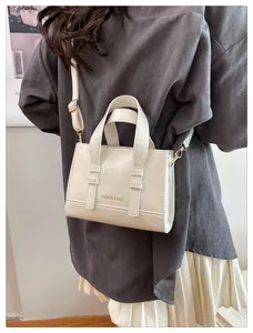 Model view showing the compact size of the off-white crossbody bag with adjustable strap
