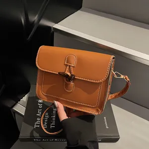 Detail of vintage caramel square bag showing contrast stitching and horn buckle closure