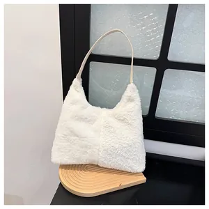 Close-up of plush white shoulder bag with soft faux fur texture and slim leather strap
