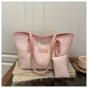 Pink tote bag set with zig-zag embroidery and small pouch on beige plush fabric