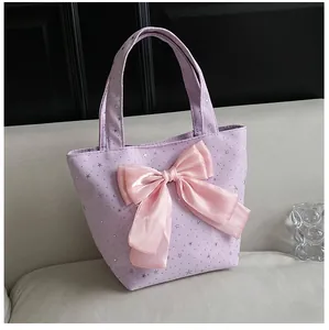 Detail of lavender tote bag with large pink satin bow and silver star patterns