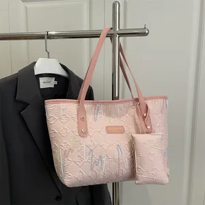Pink embossed tote bag with colorful wave embroidery and matching small pouch