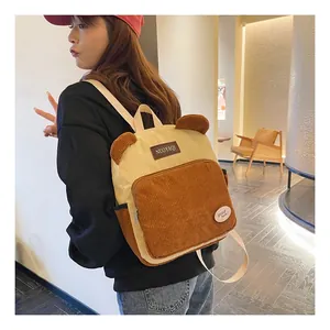 Detail of corduroy backpack with cute bear ears and stylish retro patchwork design