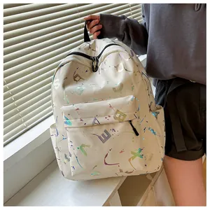 Detail of off-white backpack with colorful laser-style graffiti print and front pocket