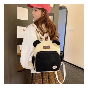 Model wearing a cute corduroy backpack with animal ears and black contrast details