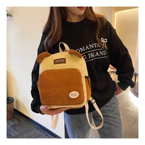 Detail of corduroy backpack with cute bear ears and embroidered lucky patch on the front