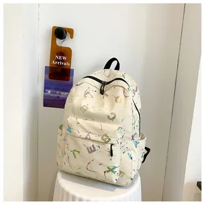 Detail of cream backpack featuring colorful gradient letter prints and multi-pocket design