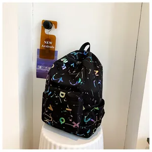 Detail of black backpack featuring colorful laser letter prints and multiple storage pockets