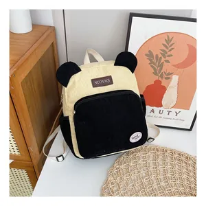 Close-up of corduroy backpack with cute animal ears and adjustable white straps