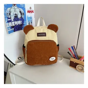 Detail of cute corduroy backpack with brown animal ears and stylish color-block design