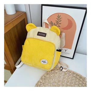 Close-up of yellow corduroy kids backpack featuring cute bear ears and front zipper pocket