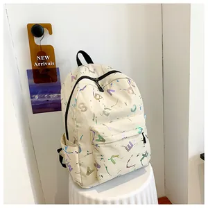 Macro view of cream white backpack with holographic text and ink splatter texture details