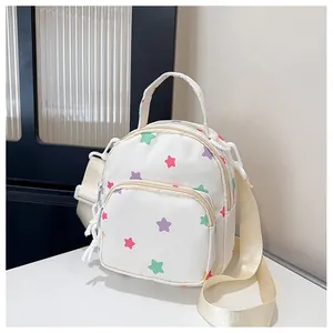 Dettaglio mini zaino con stampa a stelle, motivi colorati e tracolla larga regolabile