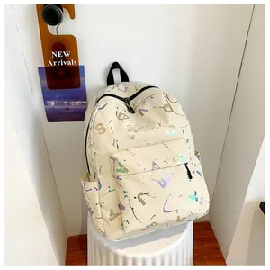 Detail view of cream white backpack featuring laser reflective patterns and side pockets