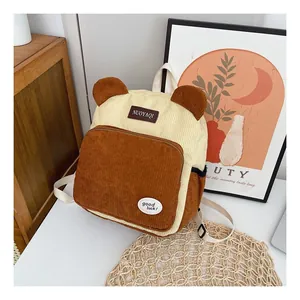 Detail view of corduroy backpack with cute bear ears and stylish patch embroidery