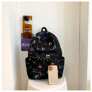 Detail showing colorful letter print and metal D-logo on black casual backpack