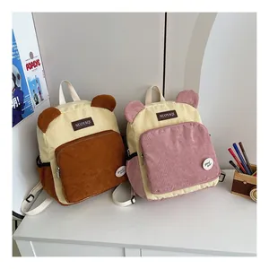 Detail of corduroy backpacks with cute bear ears and stylish brand leather patches