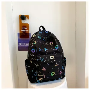 Detail of black printed backpack with vibrant letter patterns and multiple storage pockets