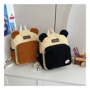 Detail of cute corduroy backpacks with bear ears, contrast colors and soft texture