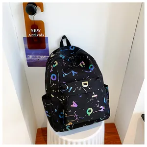 Detail of black backpack with colorful holographic letters on a white stool