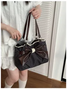 Detailed interior view of a polka dot tote bag showing large capacity for a smartphone