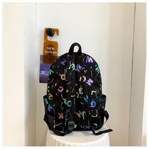 Detail of black backpack featuring vibrant gradient letter prints and side pocket design
