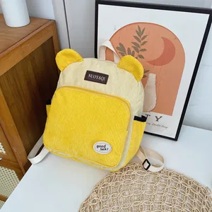 Cute yellow and beige corduroy backpack with small ears and decorative patches