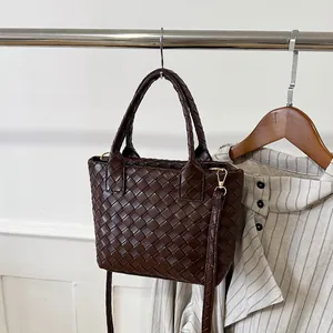 Minimalist woven bucket tote in dark coffee brown with detachable shoulder strap