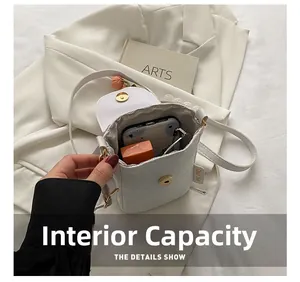 Internal capacity of mini white floral phone bag showing space for phone and lipstick
