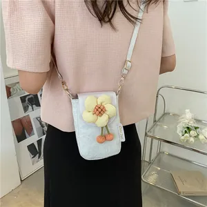 Detail of a mini crossbody bag with embossed patterns and a decorative floral accent