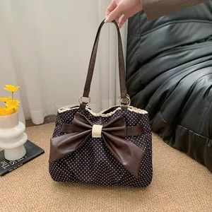 Black polka dot tote bag with brown bow decoration and lace trim, stylish lady shoulder bag