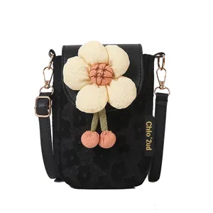 Mini floral crossbody bag in black fabric with a large cream 3D flower and pink charms