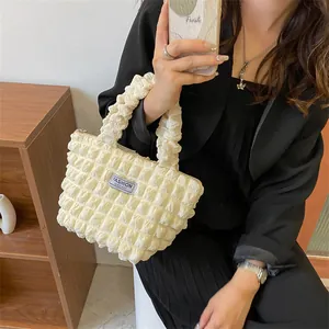 Chic beige bubble textured tote bag with scrunchie handle and fashion label
