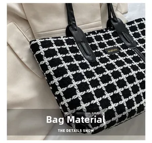 Détail du tissu en tweed à carreaux noir et blanc et des poignées en cuir de ce sac