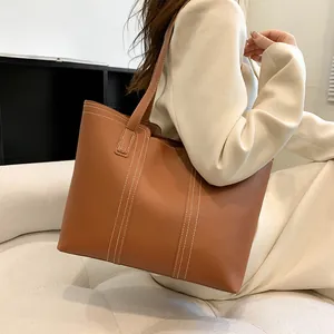 Vue détaillée du grand sac cabas marron avec des surpiqûres blanches contrastées élégantes